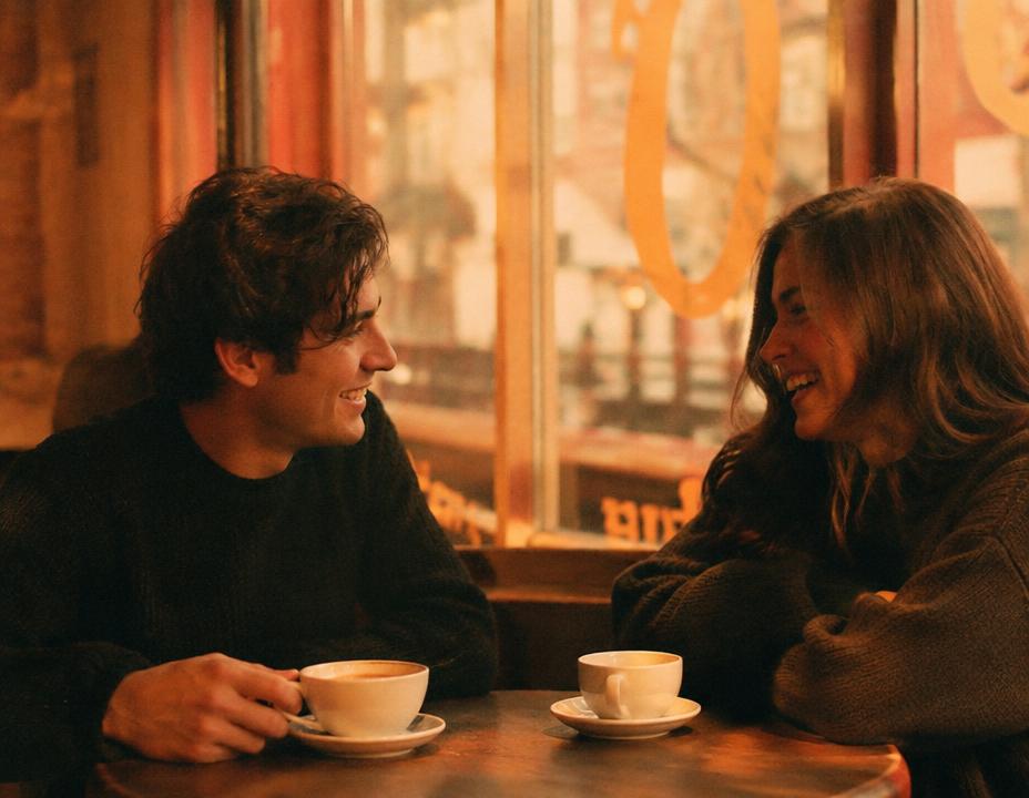 Two students laughing over coffee